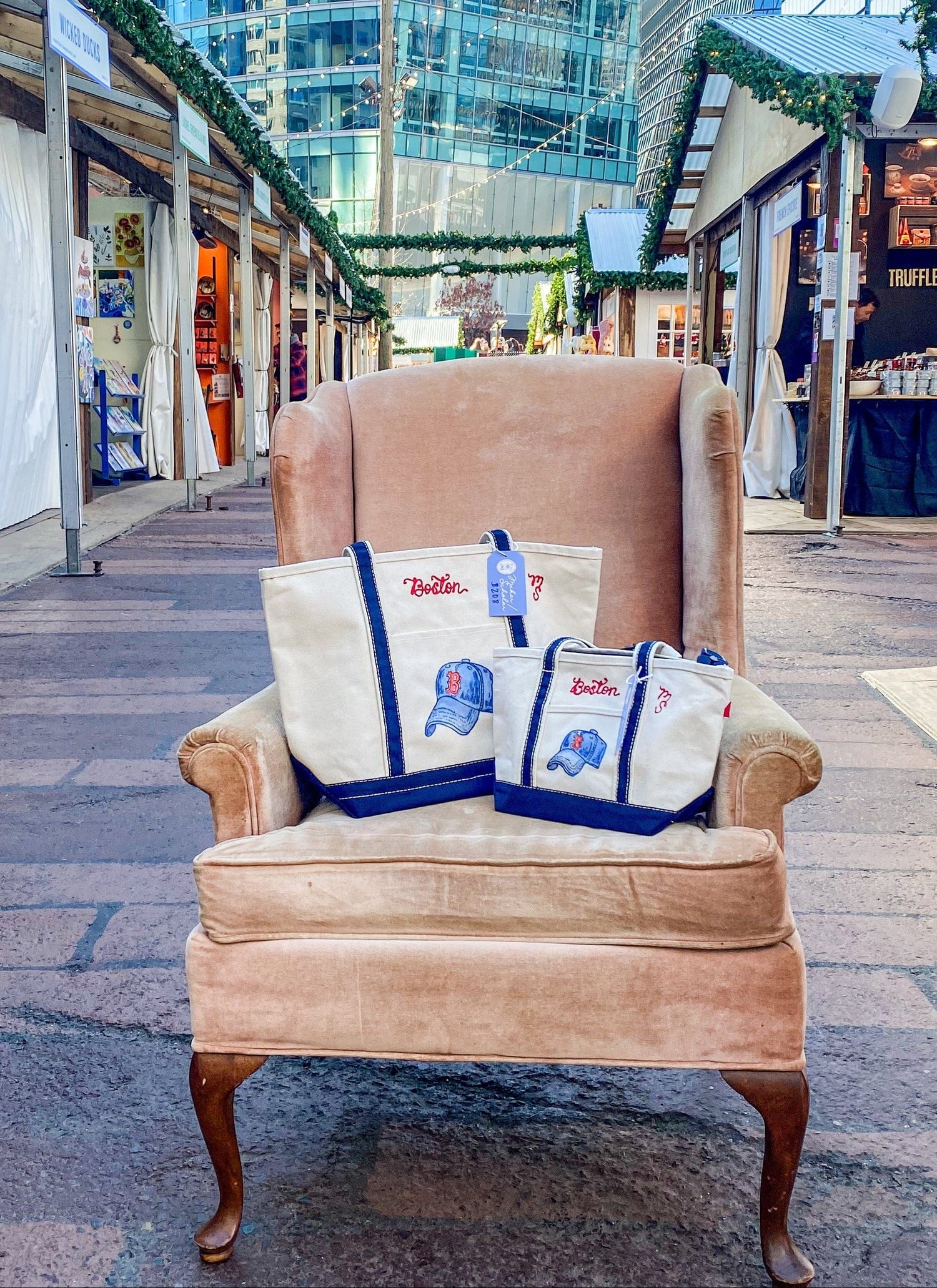 Chair with hand painted and embroidered tote bags at Snowport in the Seaport of Boston